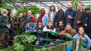 large group of people in a greenhouse