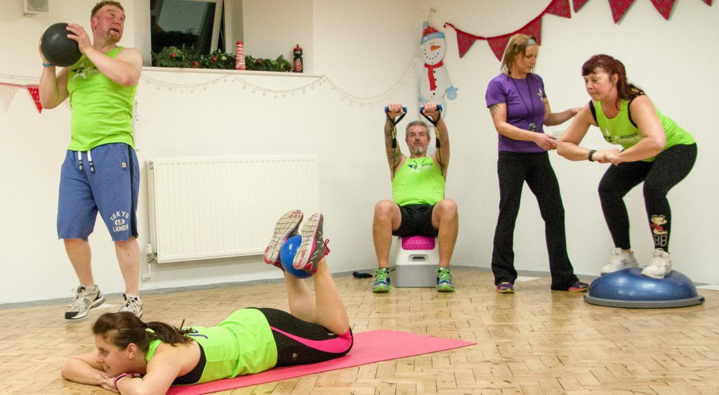 A group of people doing various exercises as part of a Bodeeworx session