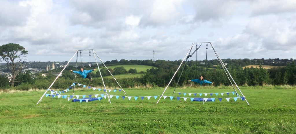 Tree Stewart, on acrobatics apparatus in a field.