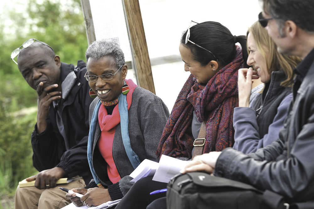 Diverse group of people smiling and talking at an SSE workshop.