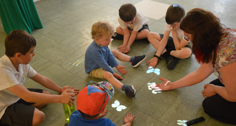 A group of children playing with an adult facilitator