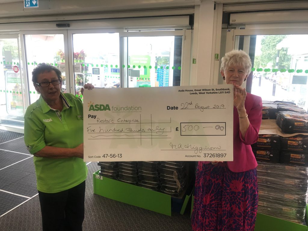 Maureen (left) who is Asda's Community Champion presenting a £500 cheque to Penny (right) - a volunteer and now a director of Restart.