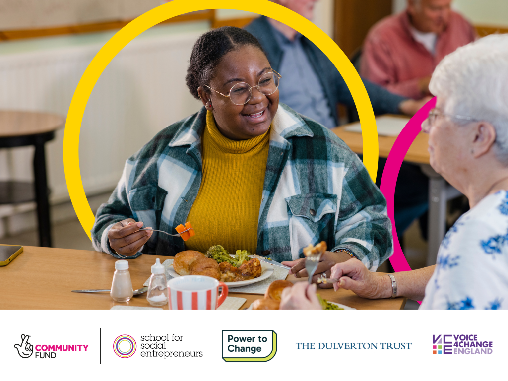 Two people laughing while eating a meal together. At the bottom are the logos for The National Lottery Community Fund, School for Social Entrpreneurs, Power To Change, The Dulverton Trust, Voice 4 Change England