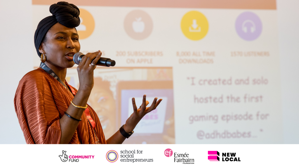 A person speaks into a microphone with a powerpoint presentation behind them